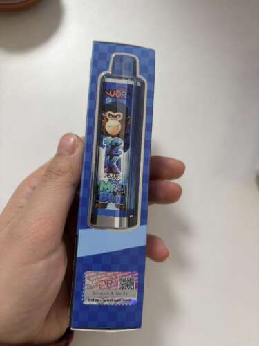 Pictured blue box containing a vape-style device with a monkey illustration and the words 12K PUFFS Mr. Blue, with a scratch-and-verify sticker at the bottom.