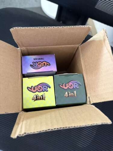 Cardboard box with three colorful small boxes labeled “4in1” and a purple box inside; neon-style logos on each box.